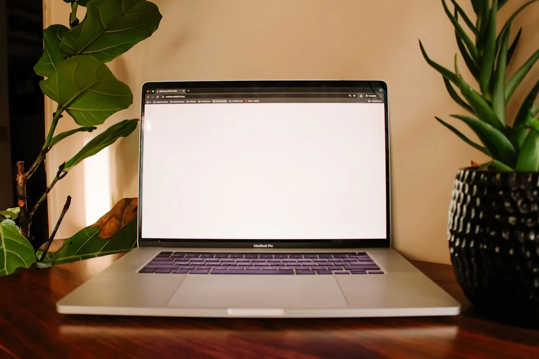 An elegant office desk arrangement showcasing Apple devices: iMac, MacBook, and iPad.
